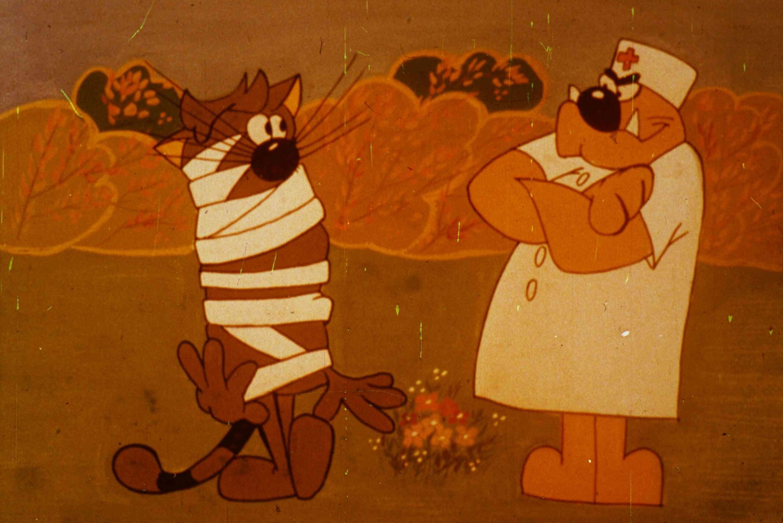 Imagine animată cu un personaj îmbrăcat în bandaje și un doctor, în contextul unei scene de tratament.