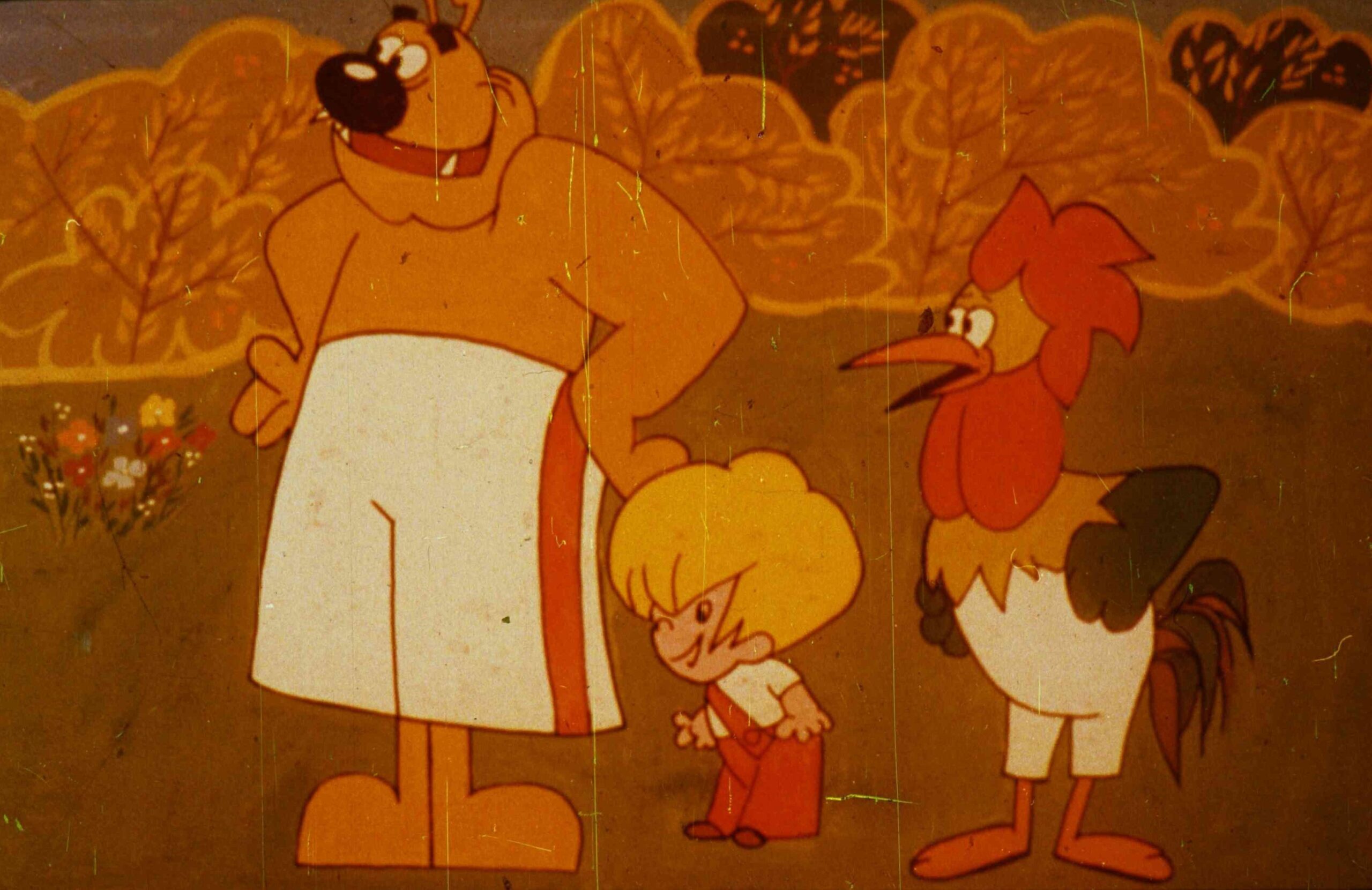 Trei personaje de desen animat discută într-un peisaj colorat, exprimând o afirmație despre comportamentul unui alt personaj.