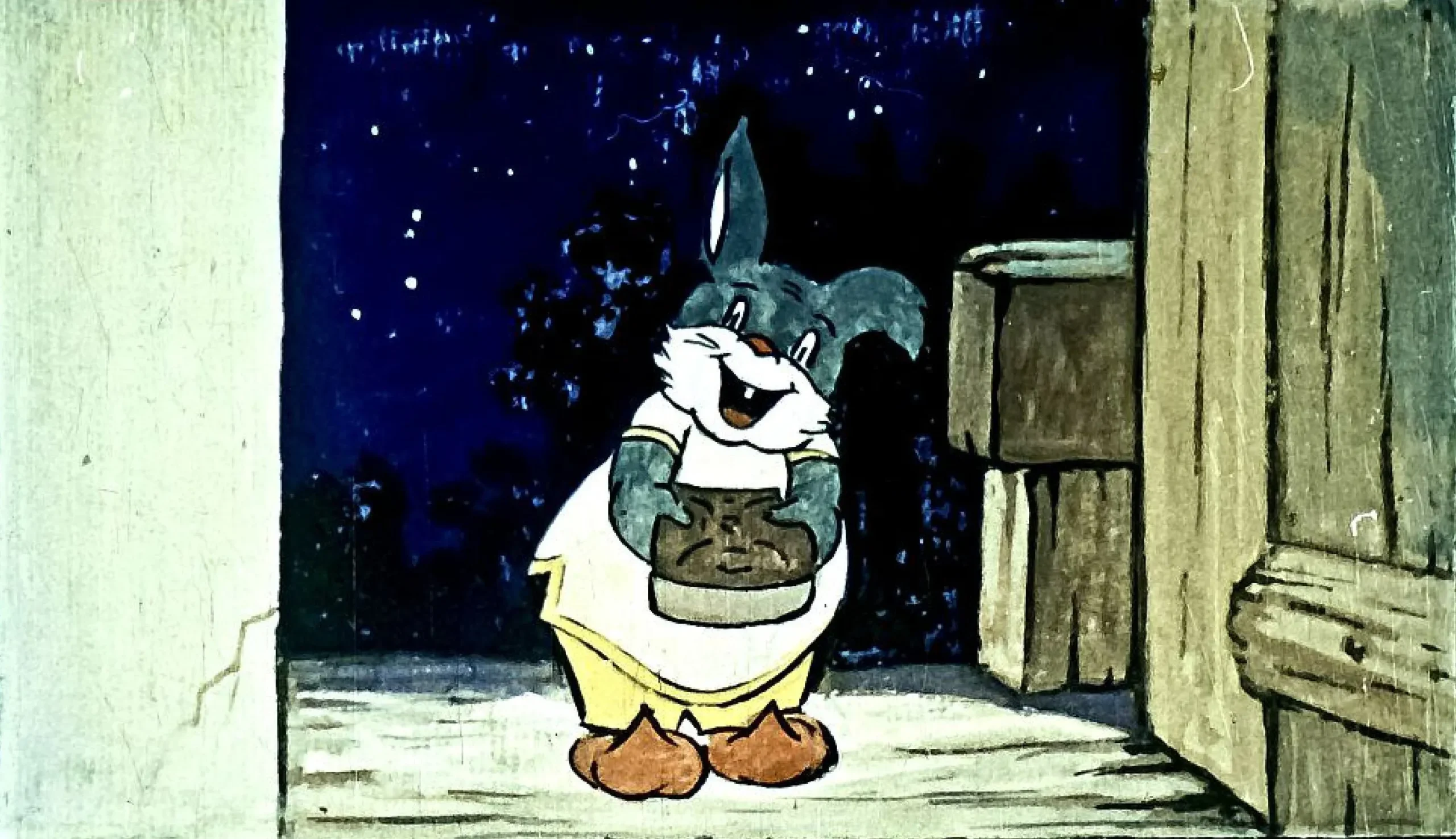 Un personaj de desene animate, un iepure, zâmbește în timp ce ține o farfurie cu turtă dulce, având un fundal nocturn.