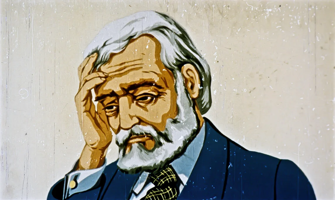 Ilustrație a unui bărbat cu păr și barbă căruntă, îmbrăcat în costum, care se ține de cap, arătând o stare de introspecție sau tristețe.