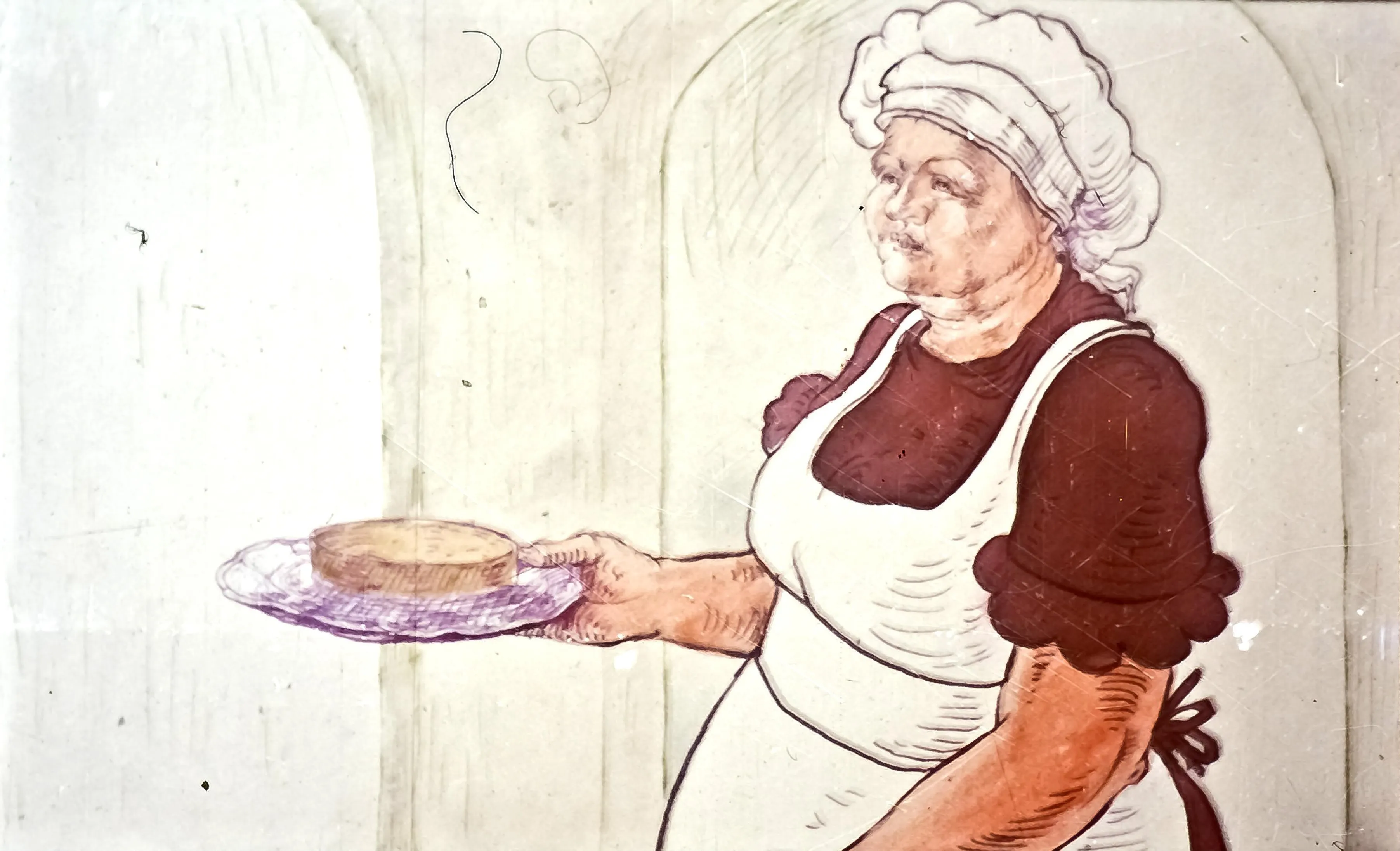 Ilustrație a unei femei, îmbrăcată ca o bucătăreasă, care ține o tavă cu un tort.